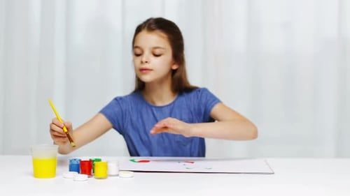 Girl Painting with Bright Paints Indoors