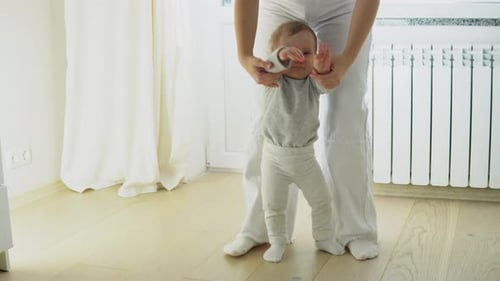 Infant Learning to Walk with Adult Assistance Indoors