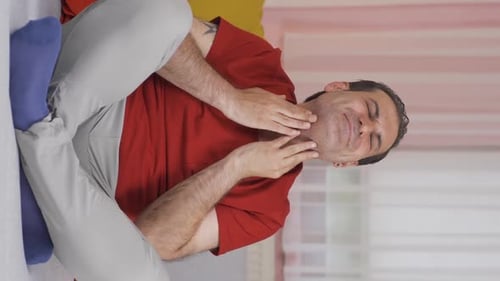 Adult Man with Sore Throat Indoor