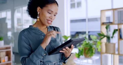 Young Woman Using Tablet in Modern Office