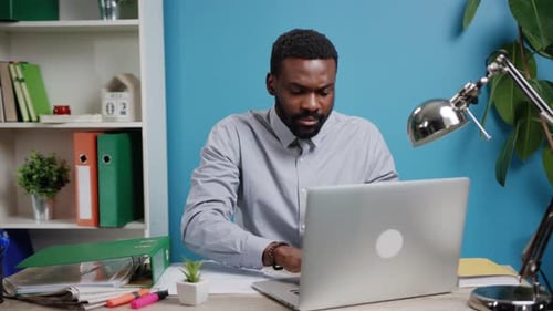 Man Working at Desk in Home Office