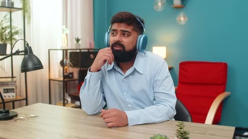 Man with beard listening to music indoors