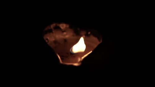 Glowing Heart Shaped Candle Flickers in the Dark