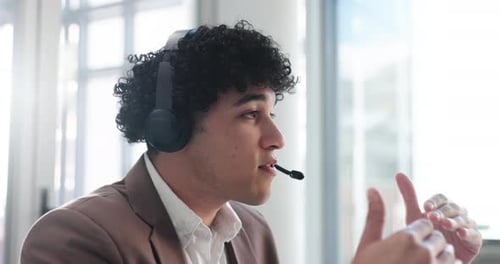 Consulting, man and talking with headset in call center for customer service, help desk and flare
