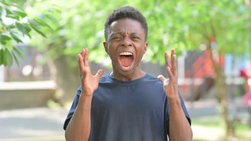 Young Adult Man Screaming Angrily Outdoors