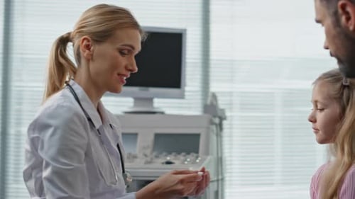 Pediatrician Checking Body Temperature in Clinic Closeup Family Doctor Talking