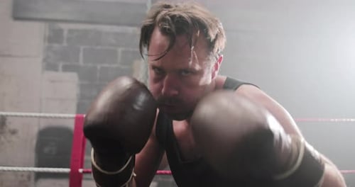 Aggressive Boxer Punches Toward Camera in Ring
