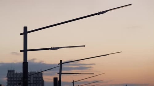 Closeup Powerful Street Lamps Silhouettes Drone . Dark Lamppost Metal Poles. Minimalistic