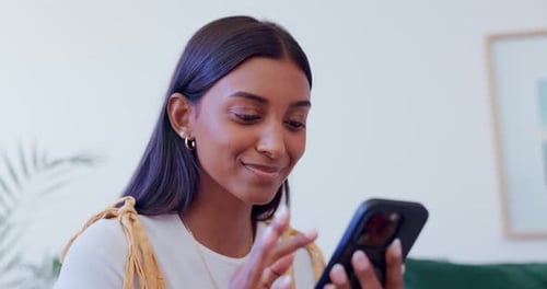 Smiling Woman Using Smartphone for Video Call at Home