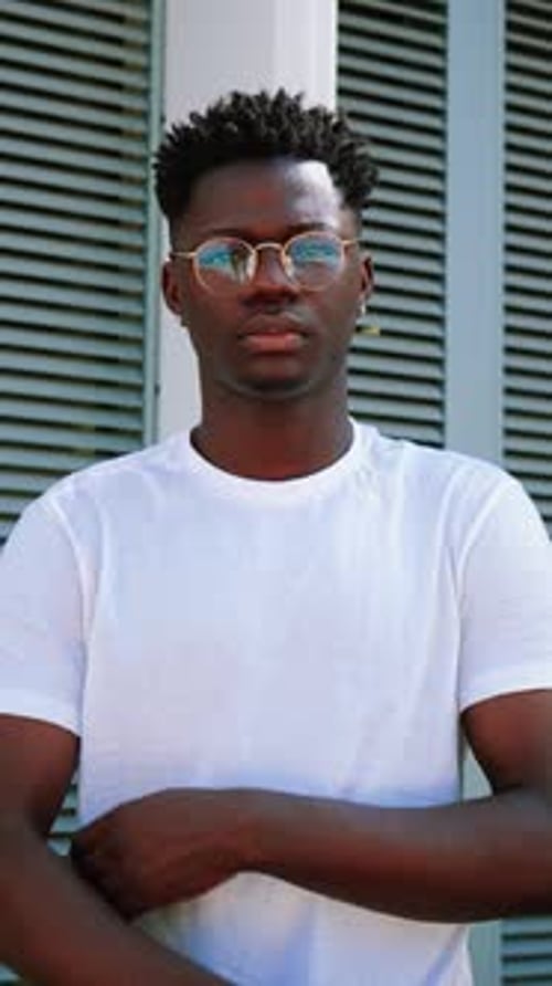 Young Adult Posing With Arms Crossed Outdoors