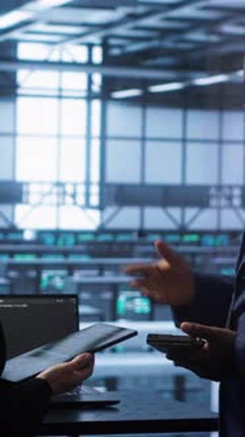 Vertical Video Teamworking Colleagues in Data Center Replacing Storage Rackmounts Components