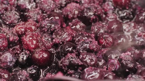 Delicious Blueberries Simmering with Spoon in Close Up