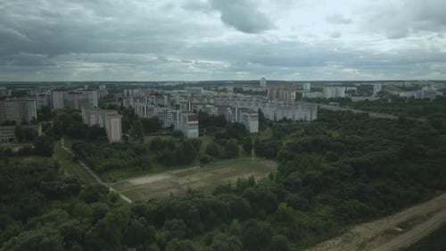 City with high-rise buildings. Park area in the foreground. Blue sky with clouds. Aerial photography