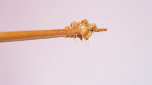 Close-Up of Natto Held by Chopsticks
