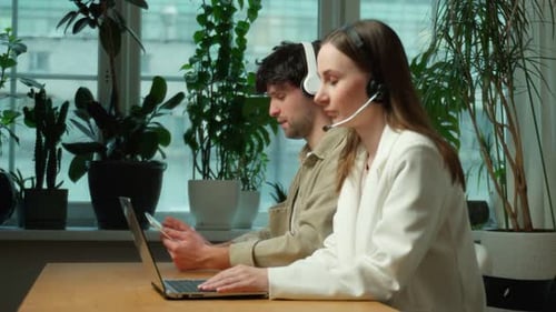 Two Happy Call Center Employees a Smiling Business Operator Customer Support Telephone Services Work
