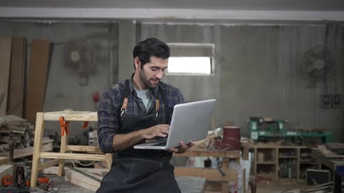 Carpenter is working at workshop.
