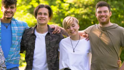 Group of friends standing together and smiling outdoors