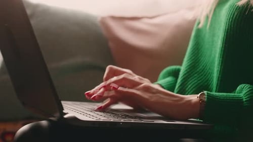 Woman Typing on Laptop While Relaxing at Home
