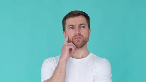 Man Thinking with Finger Near His Face