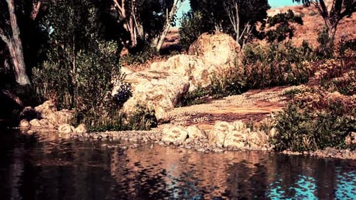 Tranquil Riverside Landscape with Lush Greenery and Rocky Features at Sunset