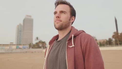 Young man enjoying walk on the beach