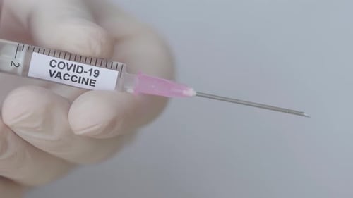 Fluid Drops Ejected From A Syringe Through Hypodermic Needle - Covid-19 Vaccine - close up