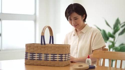 Woman Proudly Displaying Finished Woven Basket