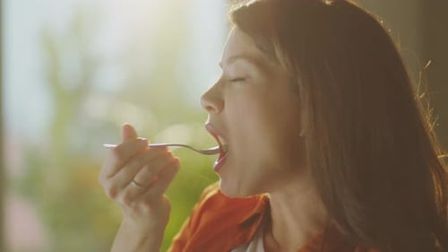 Pregnant Woman Eating Fruit Salad at Home