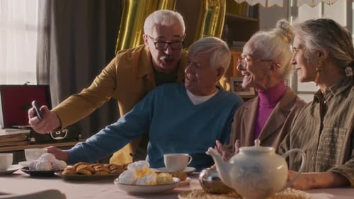 Seniors Gather Around Table for Birthday Celebration