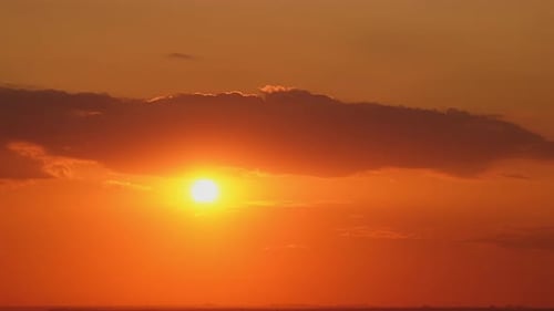 Golden Sun Rising Through Orange Clouds