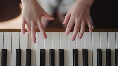 Child's Hands Playing the Piano, Close Up
