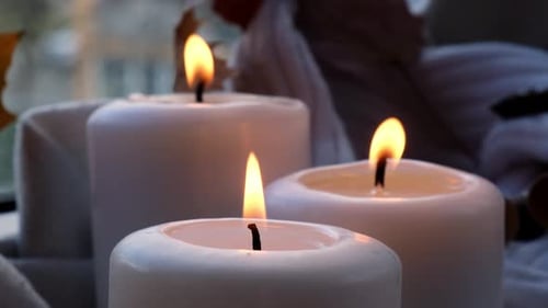 Close-Up of Three Burning White Candles