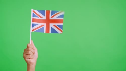 Hand Waving Small United Kingdom Flag on Green Screen