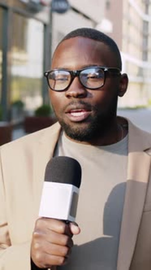 Afro American Newsman Reporting On Urban Street