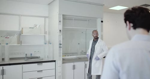 Scientists looking at data on a digital tablet