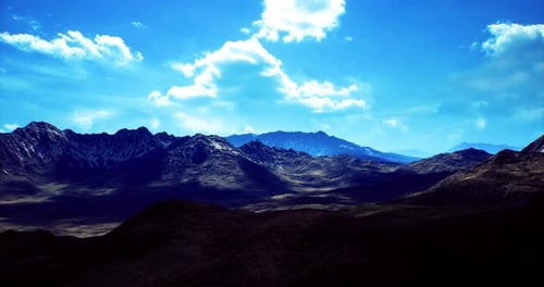 Majestätische Berglandschaft unter strahlend blauem Himmel mit flauschigen Wolken