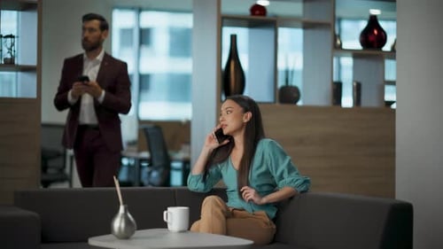 Woman Talking on Phone in Modern Office Setting
