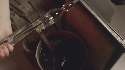 Glassblower Making Decanter Stopper in Workshop