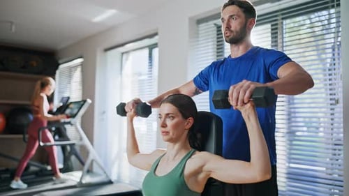 Fitness Instructor Coaching Woman in Gym Closeup Professional Sport Trainer