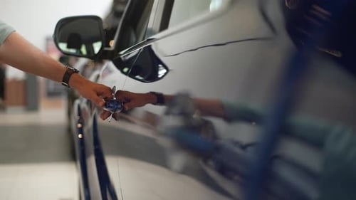 Closeup Hands of Unrecognizable Man Opening Door and Gets Into New Car in Dealership Office Indoors