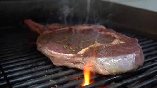 Beef steak on the grill or its flames to pass between.