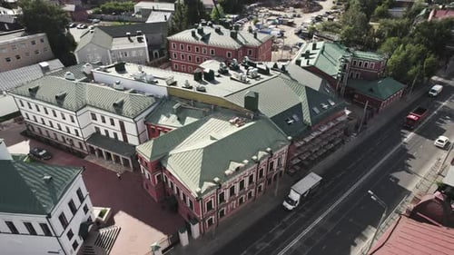Public Building Past Traffic Road with Cars Lit By Sunlight