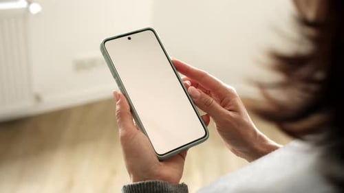 Woman Holds Smartphone With Blank White Screen