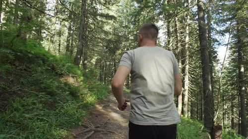 Man Jogging in the Forest Back View