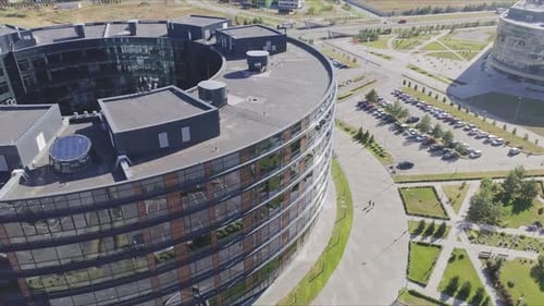 Circular Commercial Building with Glass Facade in Sunny City