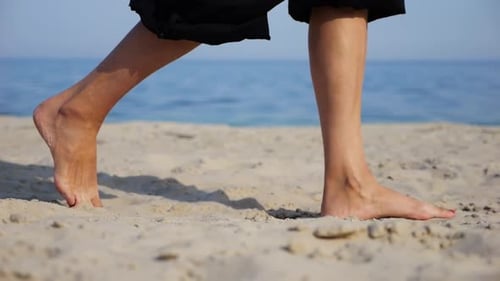 Female Feet Walking on Sand at the Beach with Seascape at Background Legs of Adult Woman Stepping