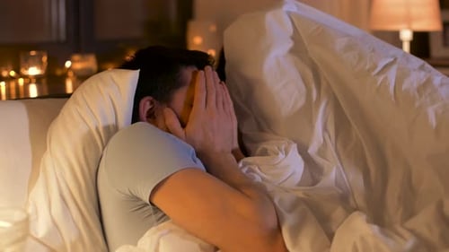 Scared Man Hides Face Watching Scary Movie with Wife