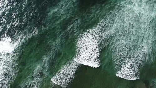 Topdown view of Ocean waves travelling on Water surface, Green Colored Atlantic Ocean