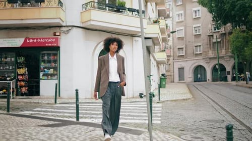 Stylish Woman in Blazer Walks City Street
