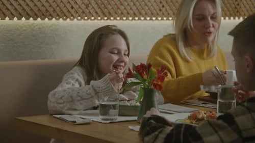 Mother with Two Kids Have Family Dinner in Cafe